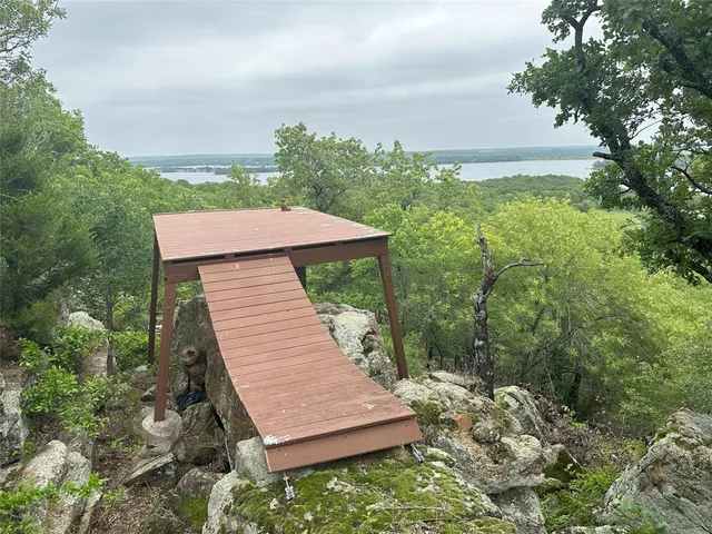 a wooden bench sitting in the middle of a forest
