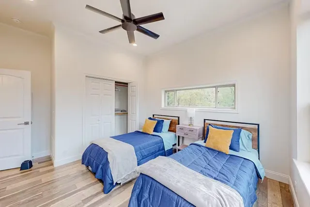 a bedroom with two beds and a window