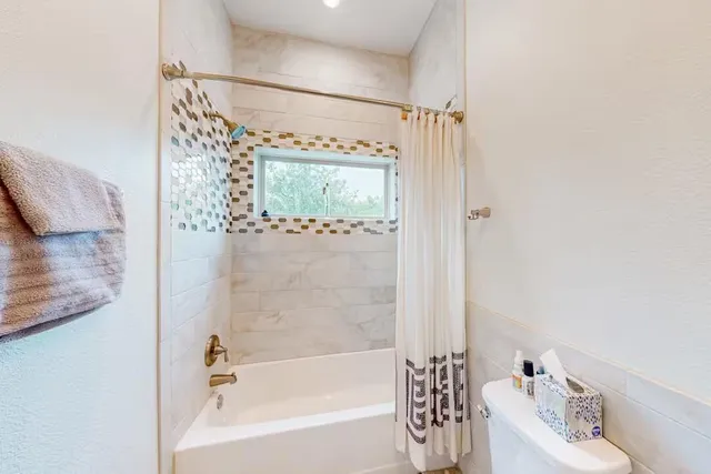 a kitchen with granite countertop a sink a counter top space and living room view