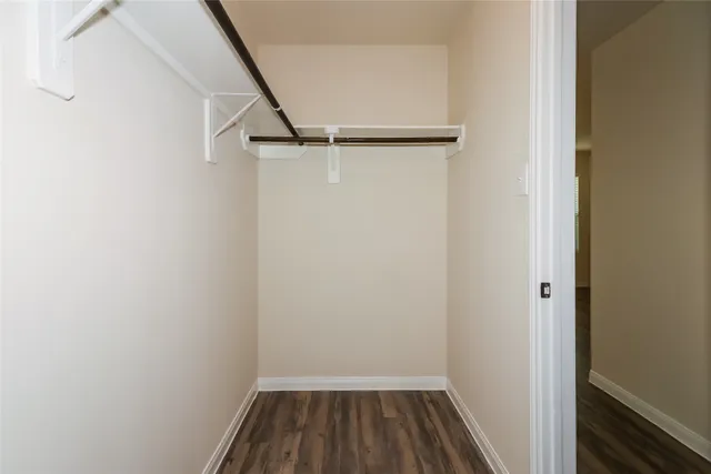 a view of a room with wooden floor and white walls
