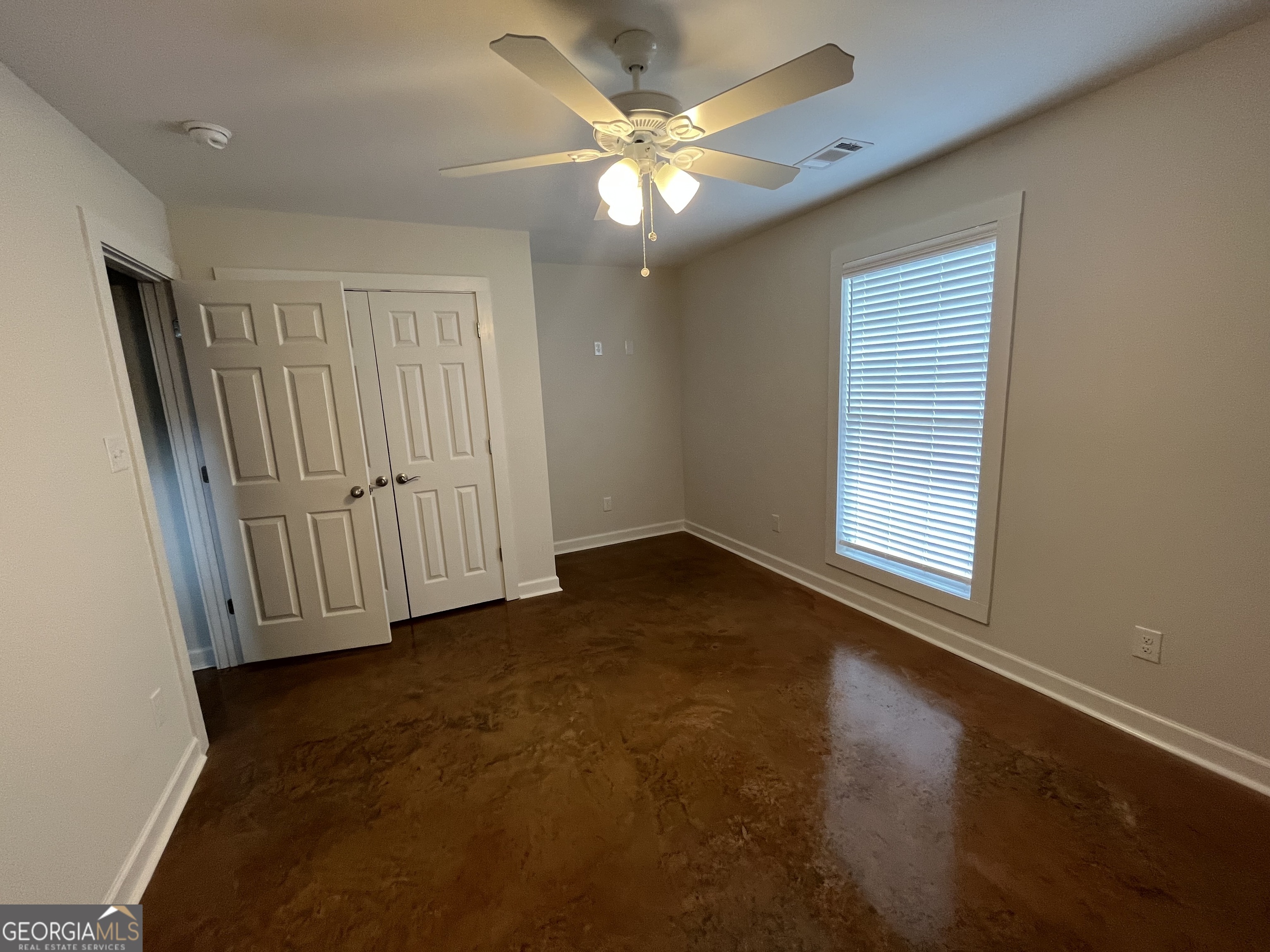 1112 3rd Street, Unit B Perry, GA 31069 - Photo 11 of 11 an empty room with windows and fan