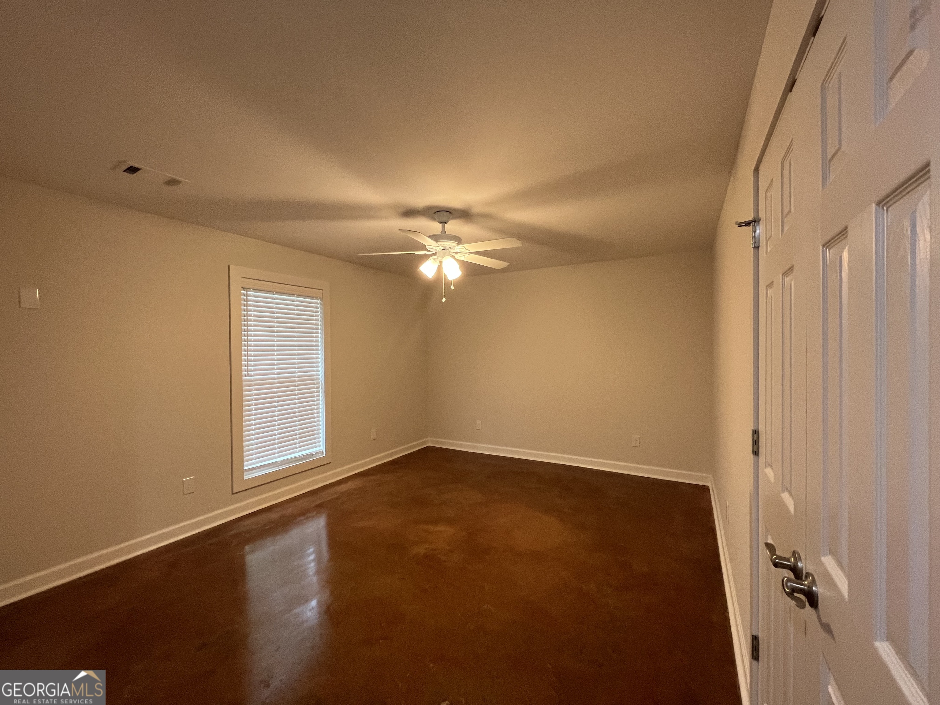 1112 3rd Street, Unit B Perry, GA 31069 - Photo 7 of 11 a view of an empty room with a window