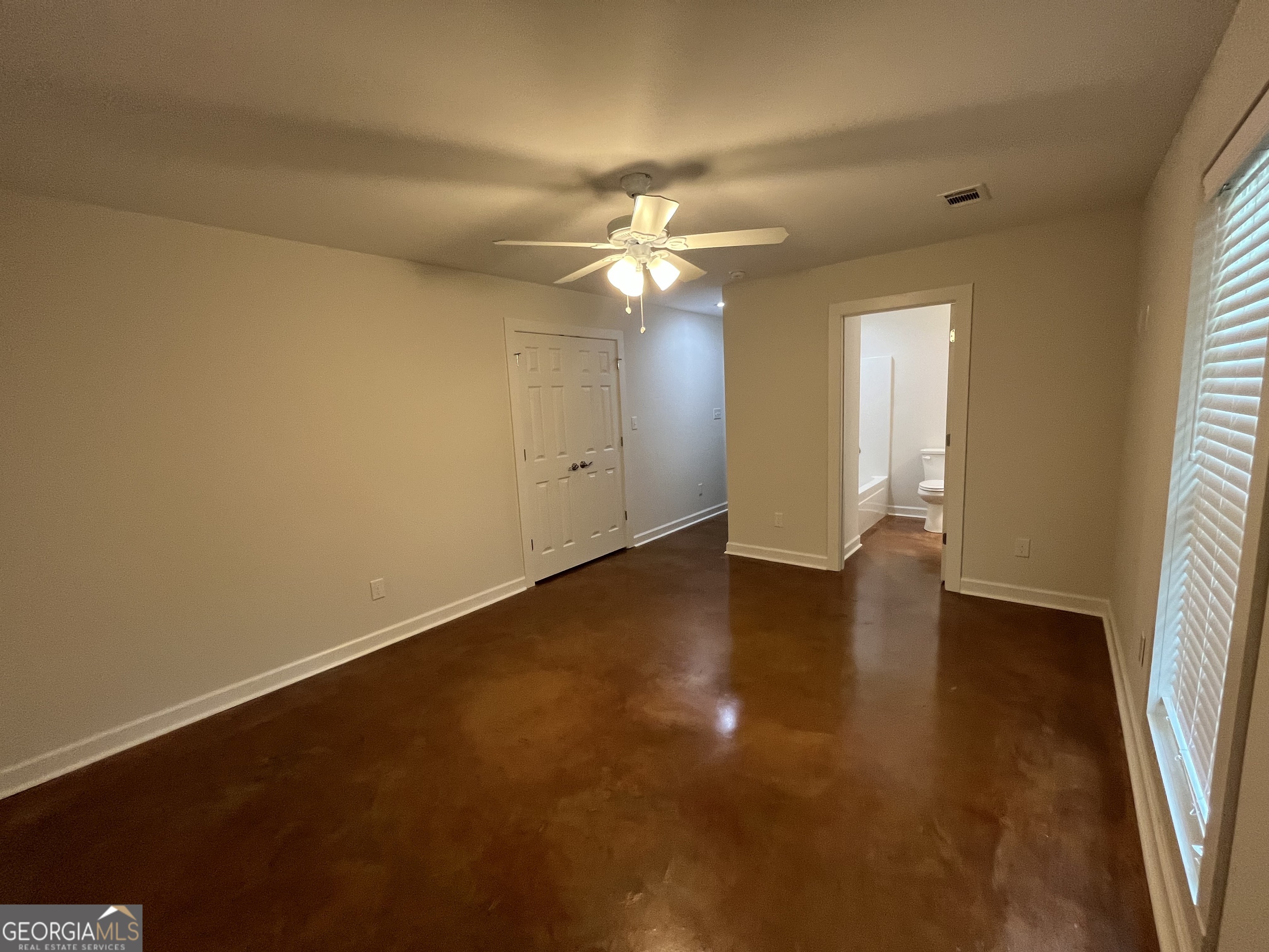 1112 3rd Street, Unit B Perry, GA 31069 - Photo 8 of 11 wooden floor in an empty room with a window