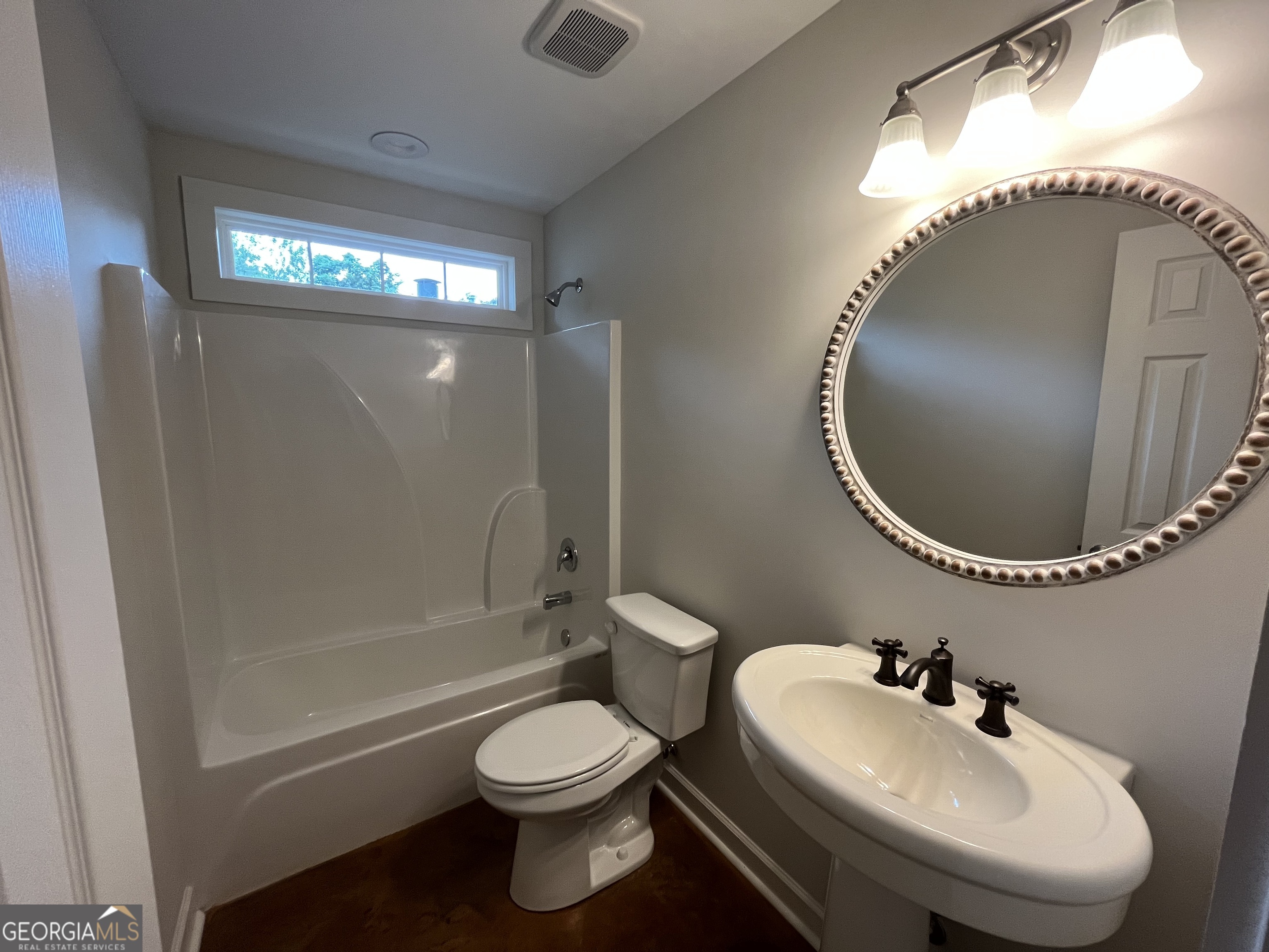 1112 3rd Street, Unit B Perry, GA 31069 - Photo 10 of 11 a bathroom with a toilet sink and mirror