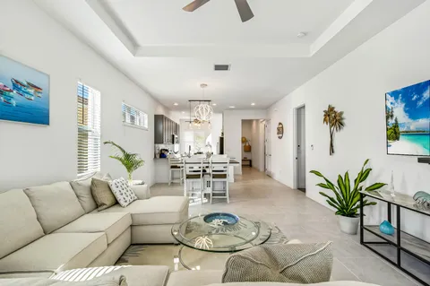 a living room with furniture potted plant and a table