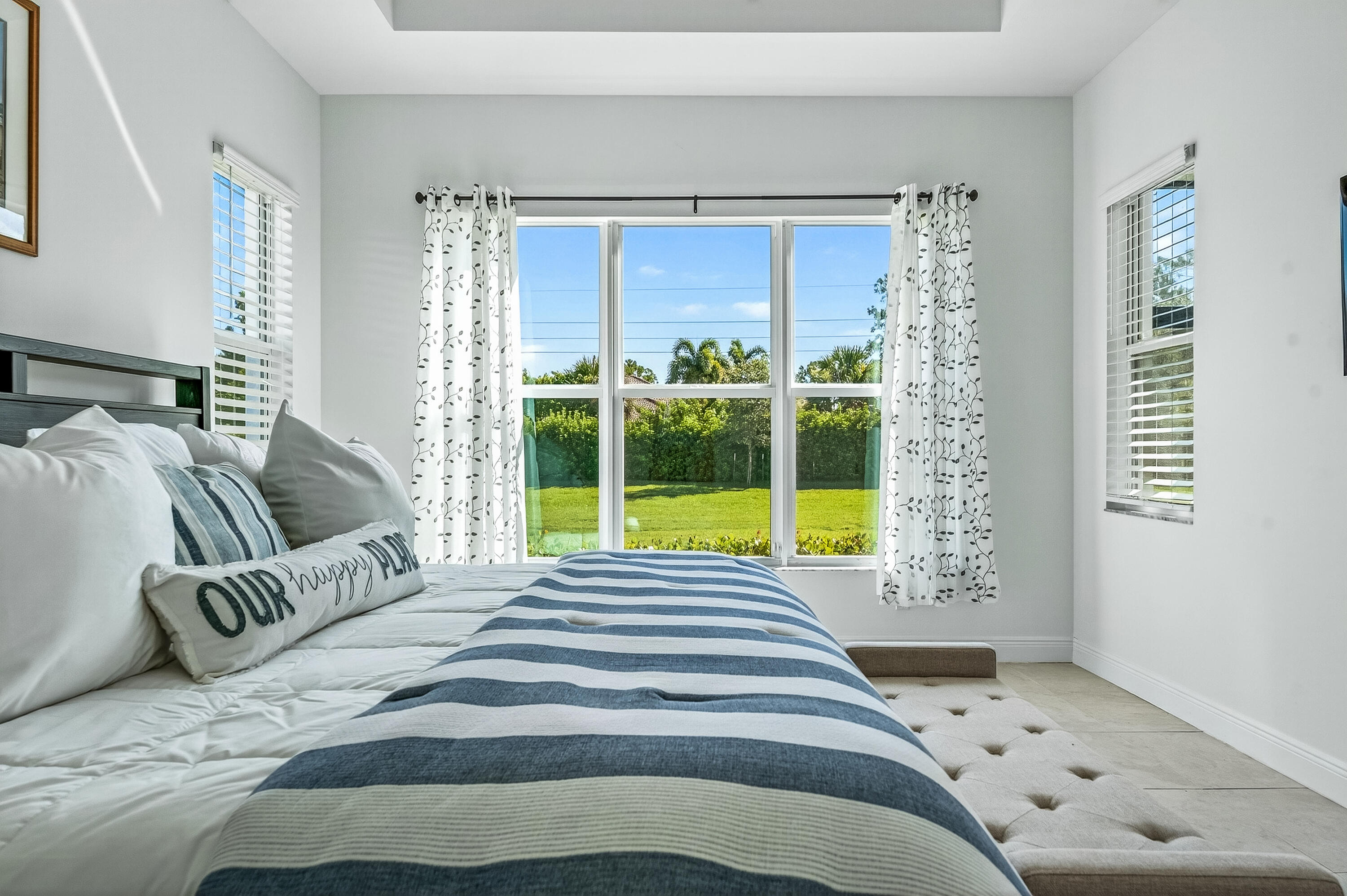 11461 Southwest Visconti Way Port St. Lucie, FL 34986 - Photo 20 of 32 a bedroom with a bed and a large window