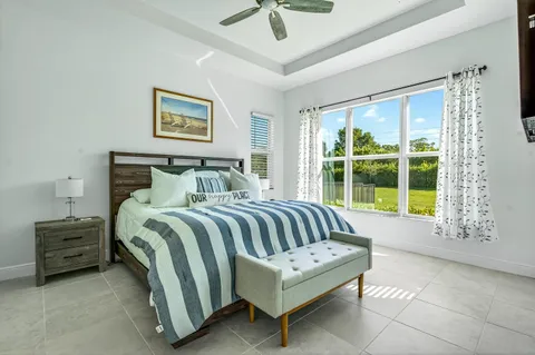 a bedroom with a bed a couch and a window