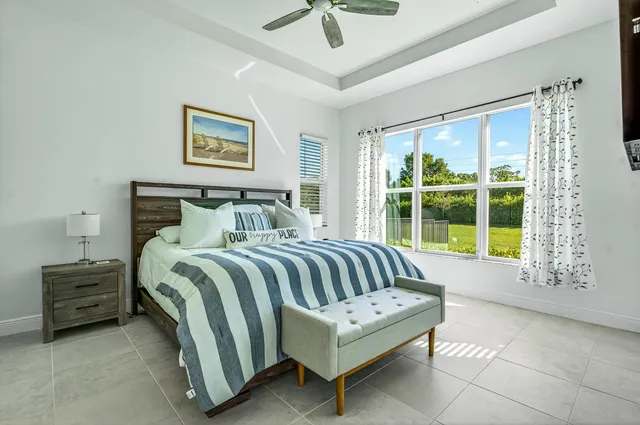 a bedroom with a bed a couch and a window