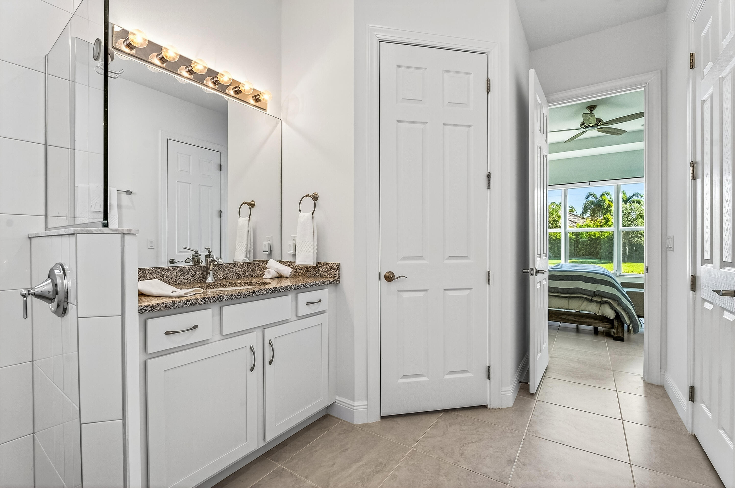 11461 Southwest Visconti Way Port St. Lucie, FL 34986 - Photo 22 of 32 a bathroom with a granite countertop sink and a mirror