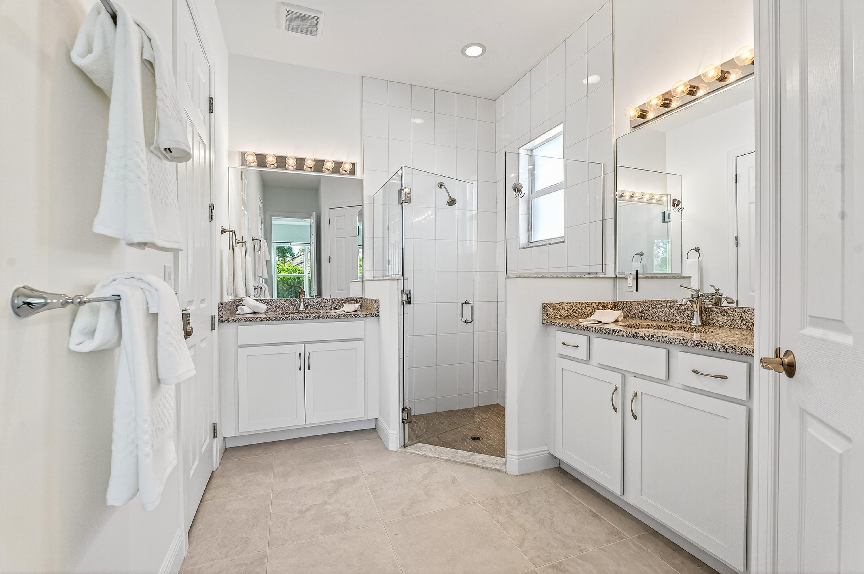 11461 Southwest Visconti Way Port St. Lucie, FL 34986 - Photo 23 of 32 a bathroom with a granite countertop sink a mirror and a shower