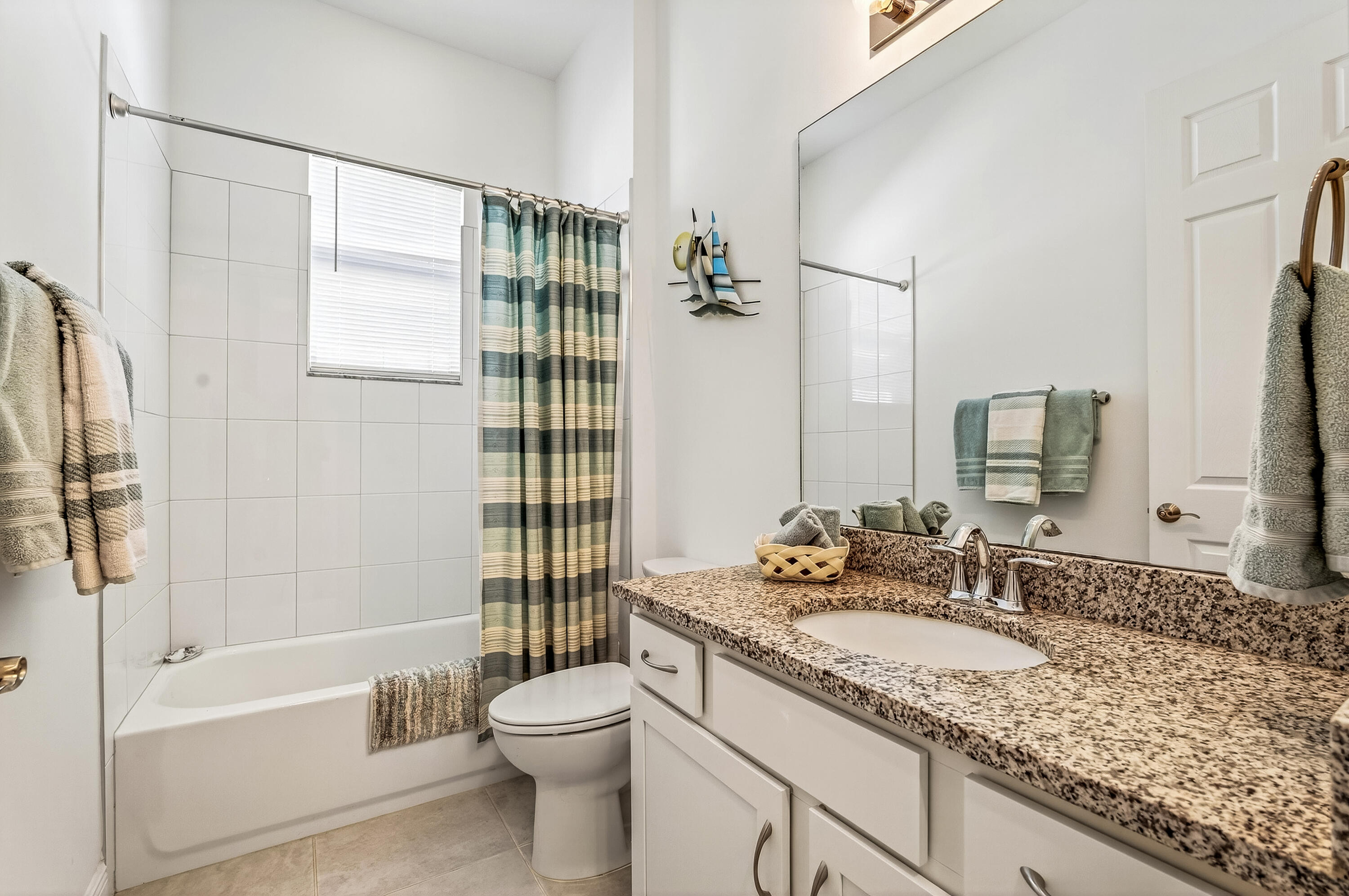 11461 Southwest Visconti Way Port St. Lucie, FL 34986 - Photo 25 of 32 a bathroom with a granite countertop sink and a mirror