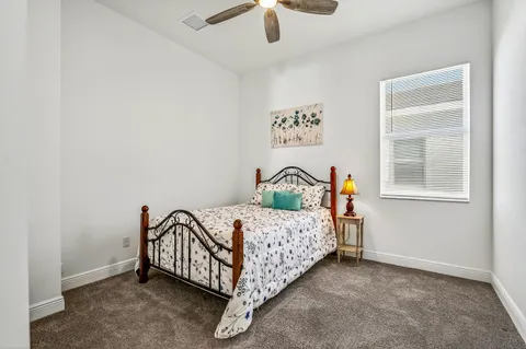 a bed sitting in a bedroom next to a window