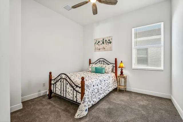 a bed sitting in a bedroom next to a window