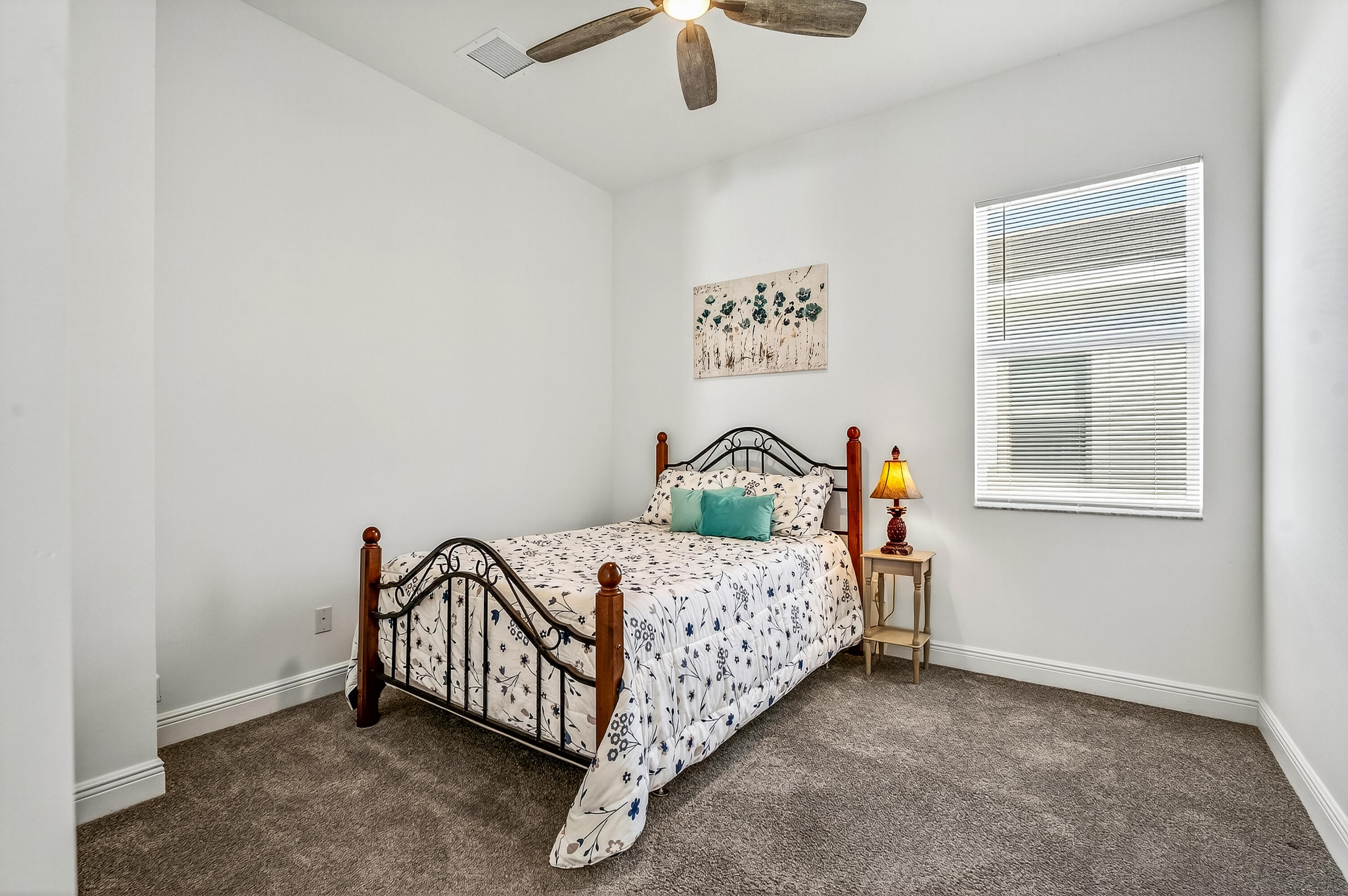 11461 Southwest Visconti Way Port St. Lucie, FL 34986 - Photo 26 of 32 a bed sitting in a bedroom next to a window