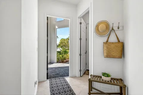 a view of a hallway with entryway wooden floor and front door