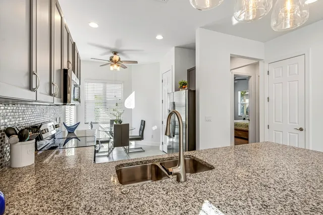 a kitchen with sink refrigerator and fireplace