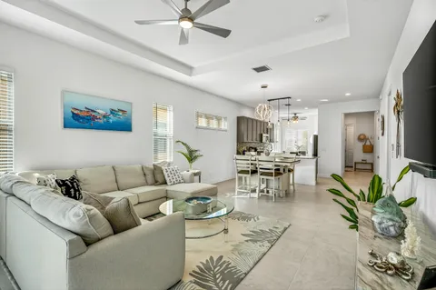a living room with furniture kitchen view and a dining table