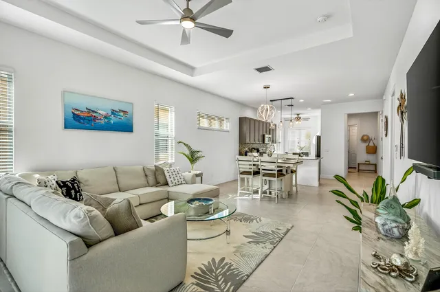 a living room with furniture kitchen view and a dining table