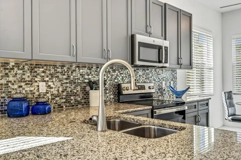 a kitchen with a sink and a stove top oven