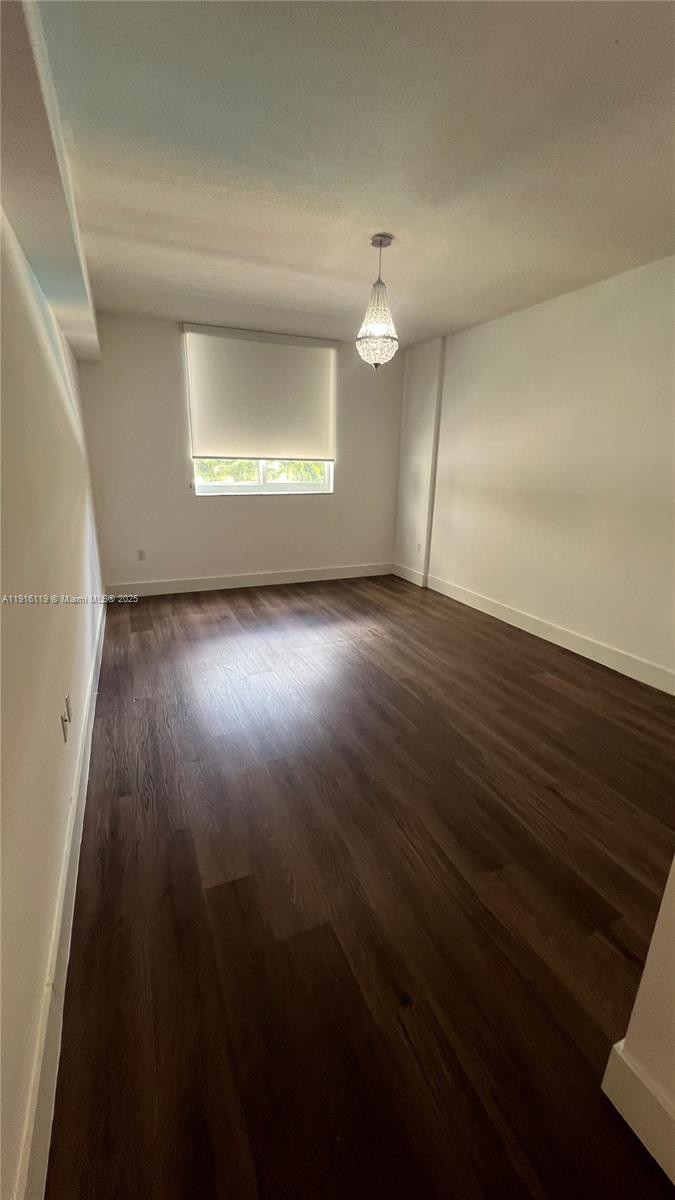 2775 Northeast 187th Street, Unit 227 Aventura, FL 33180 - Photo 4 of 17 an empty room with wooden floor and windows