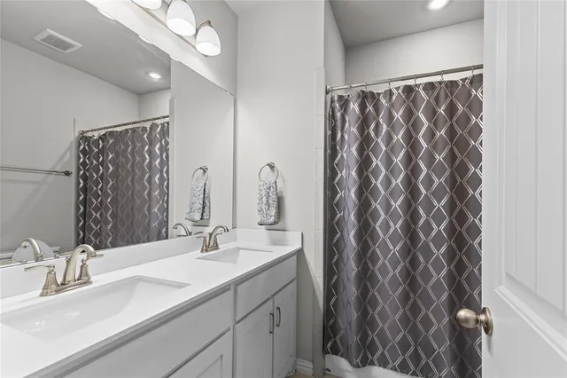 a bathroom with a double vanity sink and a mirror