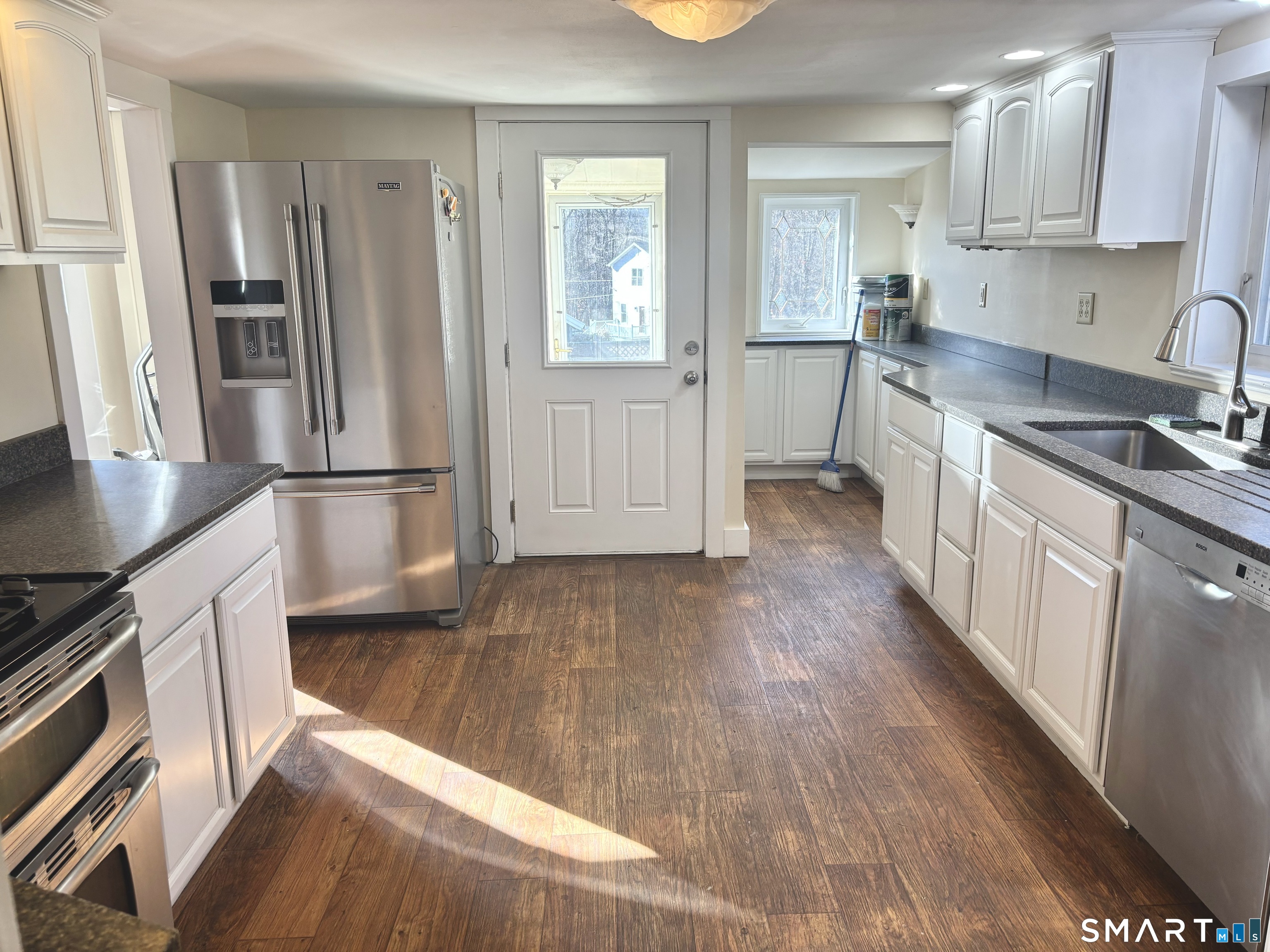 336 Reservoir Avenue Meriden, CT 06451 - Photo 6 of 17 a kitchen with granite countertop a refrigerator and a stove top oven