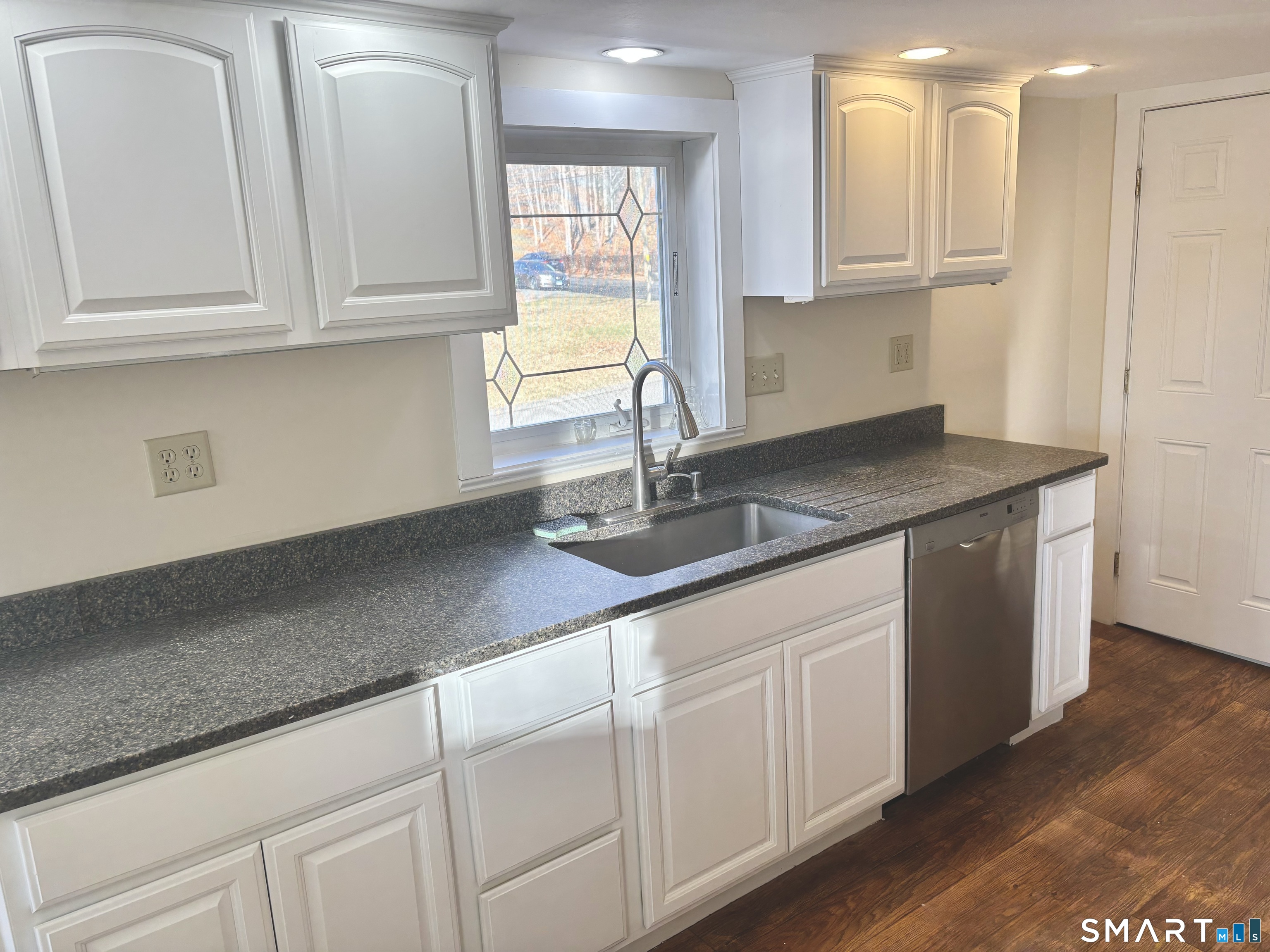 336 Reservoir Avenue Meriden, CT 06451 - Photo 8 of 17 a kitchen with white cabinets and sink