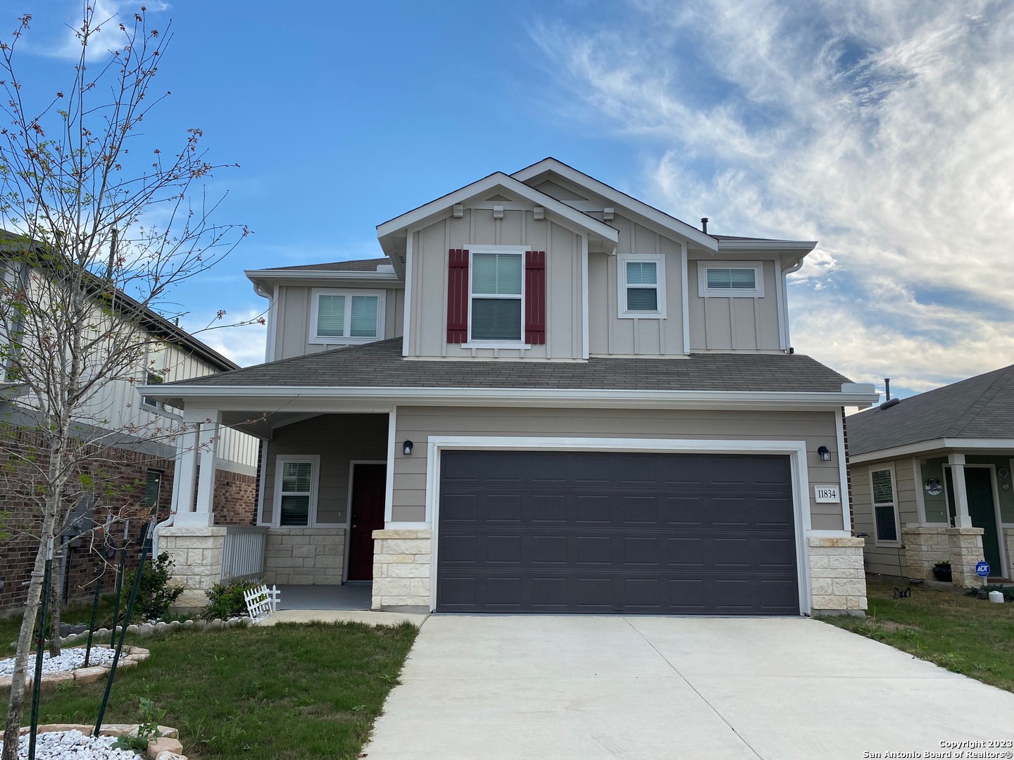 a front view of a house with a yard and garage