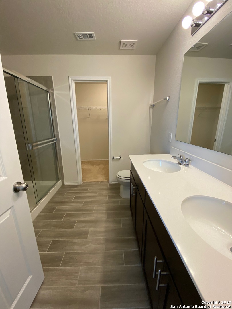 11834 Burnett Ranch San Antonio, TX 78254 - Photo 11 of 18 a bathroom with sink shower and a mirror