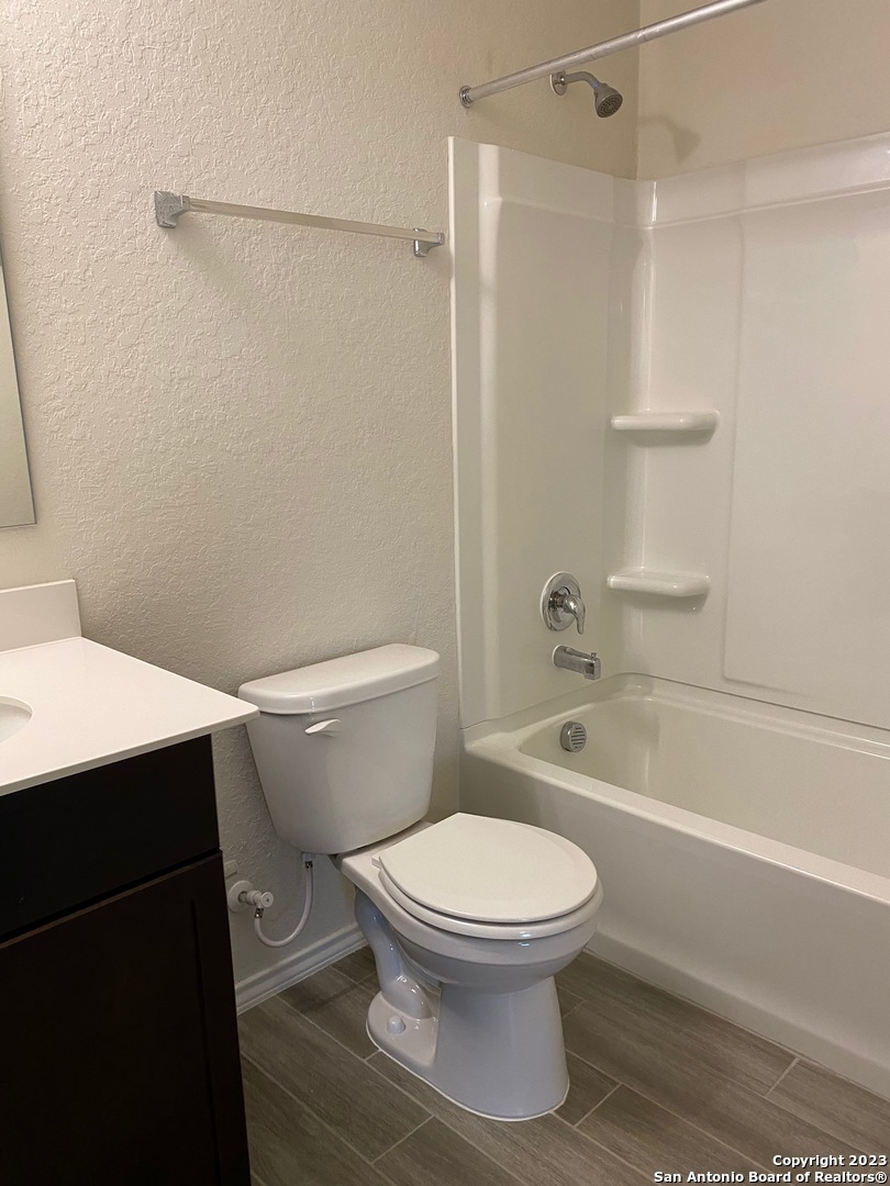 11834 Burnett Ranch San Antonio, TX 78254 - Photo 15 of 18 a white toilet and tub sitting next to a bathroom sink