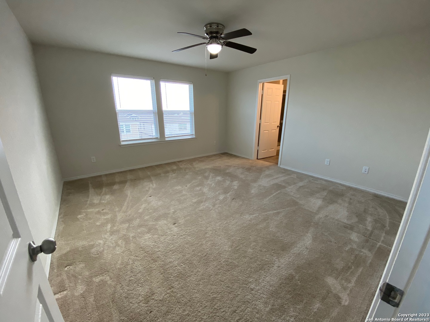 11834 Burnett Ranch San Antonio, TX 78254 - Photo 10 of 18 an empty room with windows and fan