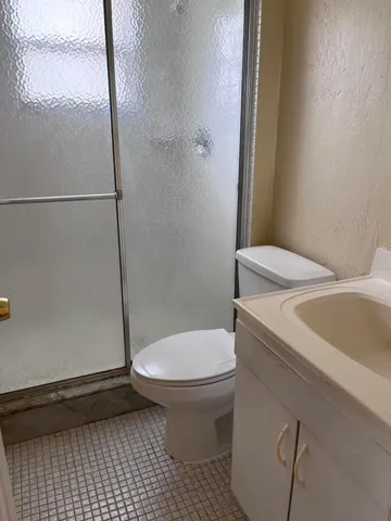 a bathroom with a sink a toilet and a shower