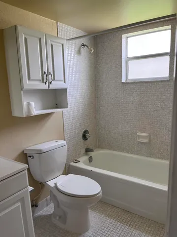 a bathroom with a toilet a sink and bathtub
