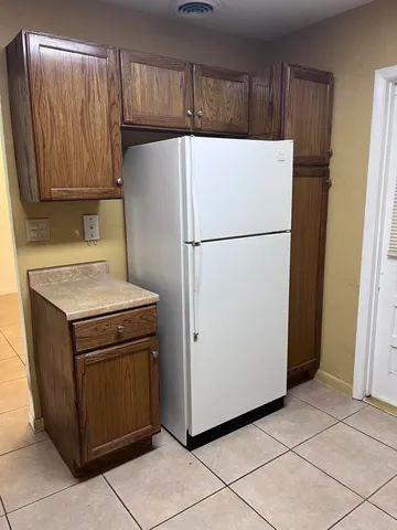 a white refrigerator freezer sitting in a kitchen