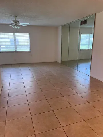 a view of a livingroom with wooden floor and a window