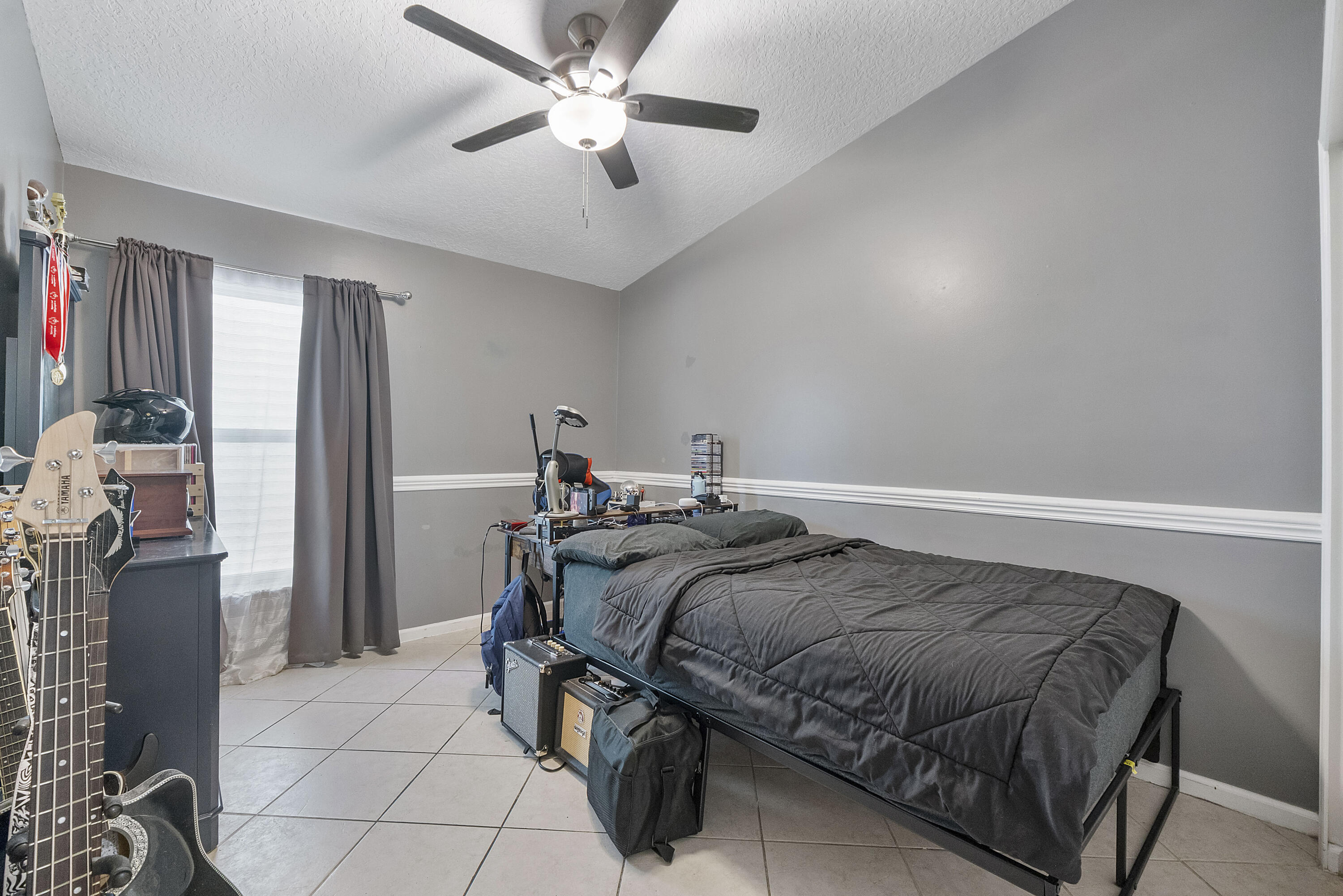 12328 St Simon Drive Boca Raton, FL 33428 - Photo 26 of 52 a bed sitting in a room next to a window and a chandelier