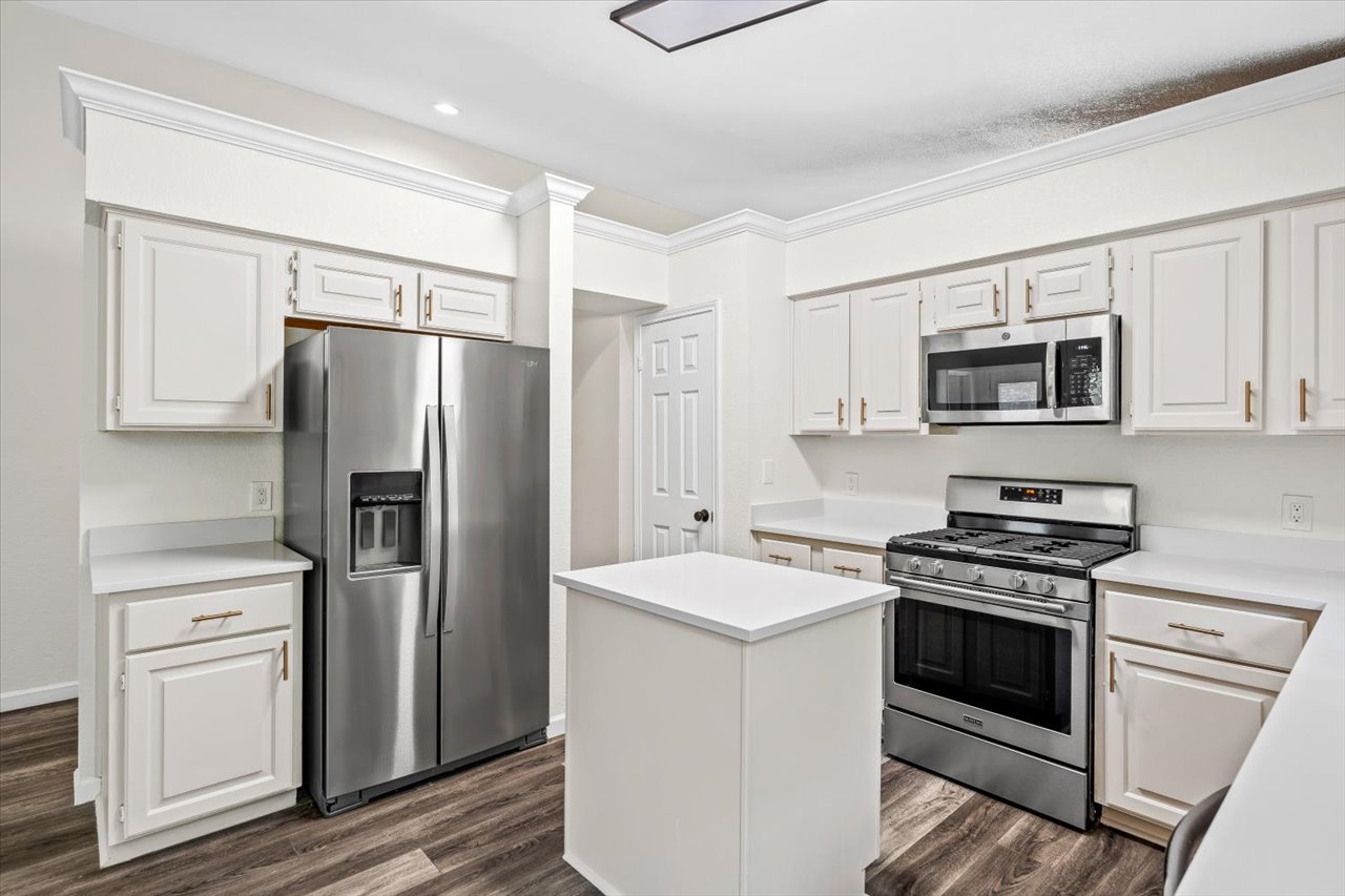 4004 Danli Lane Austin, TX 78749 - Photo 24 of 40 a kitchen with white cabinets and stainless steel appliances