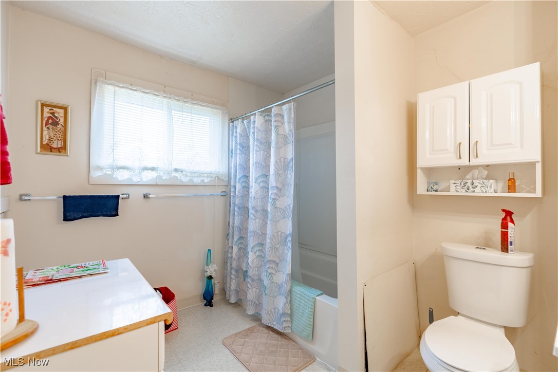 900 4th Street Southwest Canton, OH 44707 - Photo 18 of 31 Bathroom featuring shower / bath combination with curtain, vanity, and light flooring