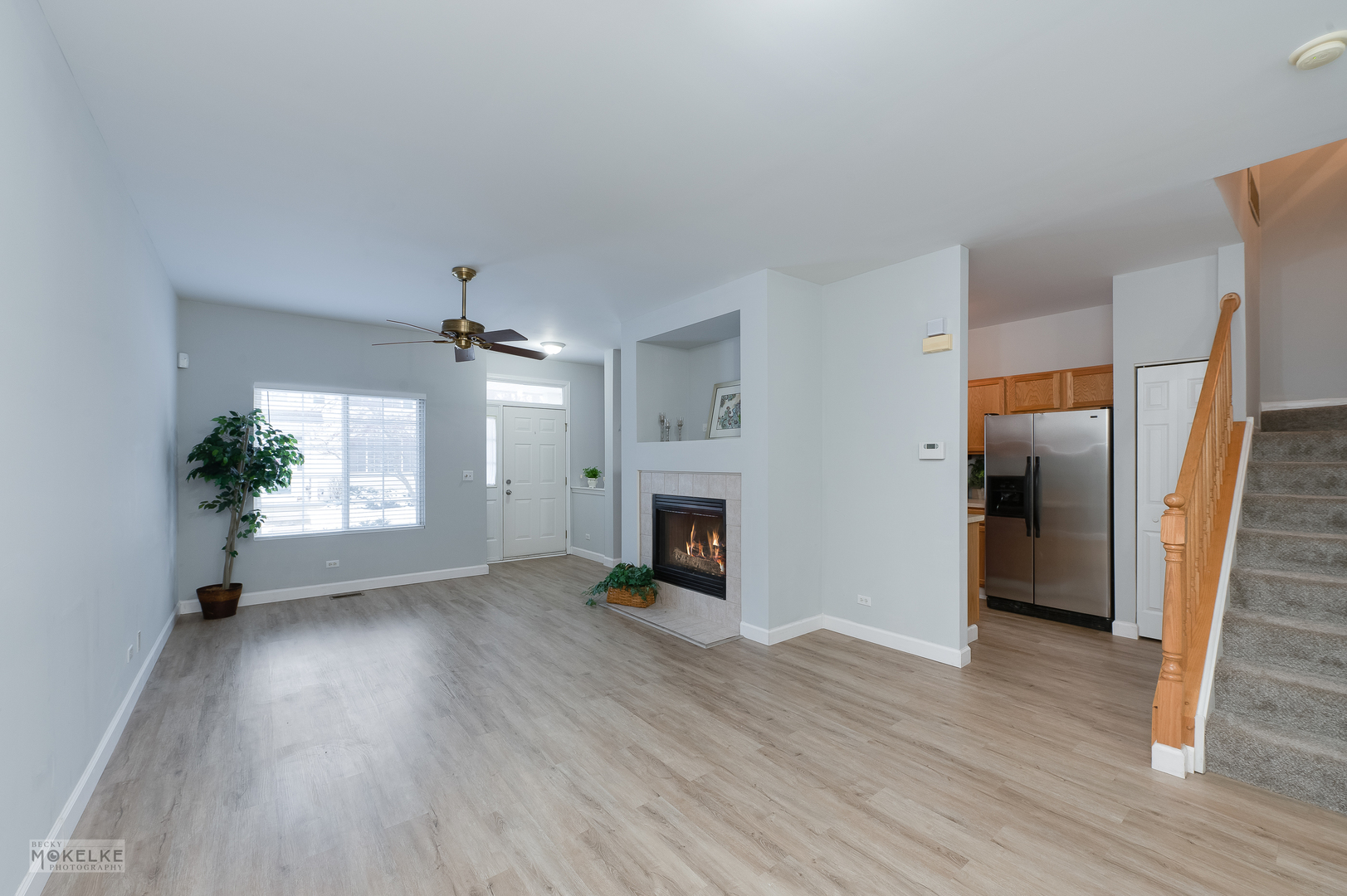 802 County Line Road, Unit 802 Aurora, IL 60502 - Photo 4 of 24 an empty room with wooden floor fireplace and windows