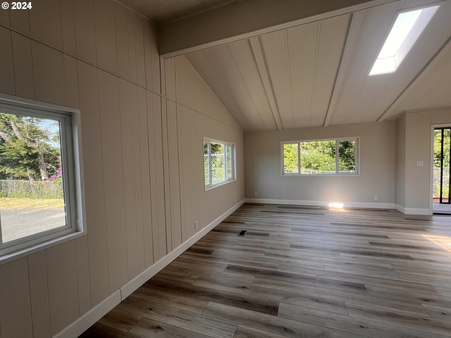 100 River Bend Road, Unit 4 Reedsport, OR 97467 - Photo 16 of 39 a view of an empty room with wooden floor and a window