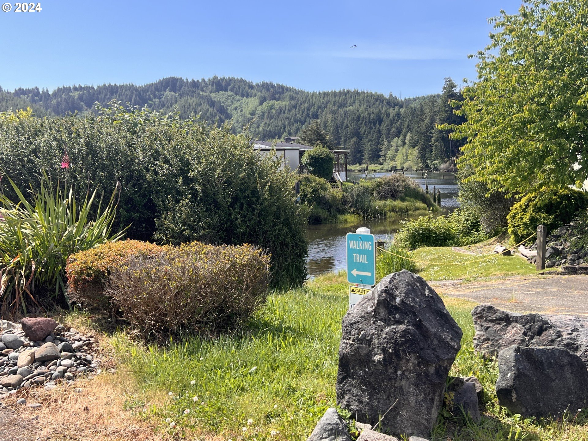 100 River Bend Road, Unit 4 Reedsport, OR 97467 - Photo 33 of 39 a view of a garden with mountain