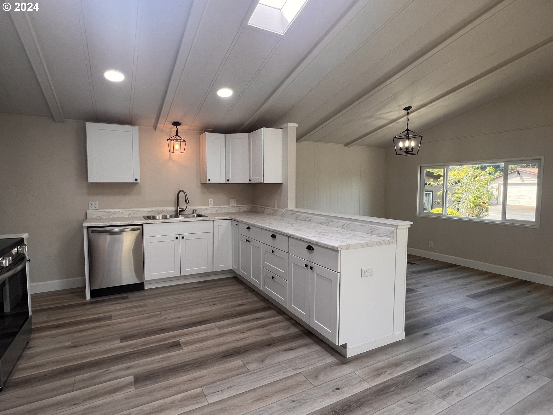 100 River Bend Road, Unit 4 Reedsport, OR 97467 - Photo 8 of 39 a kitchen with stainless steel appliances sink cabinets and wooden floor