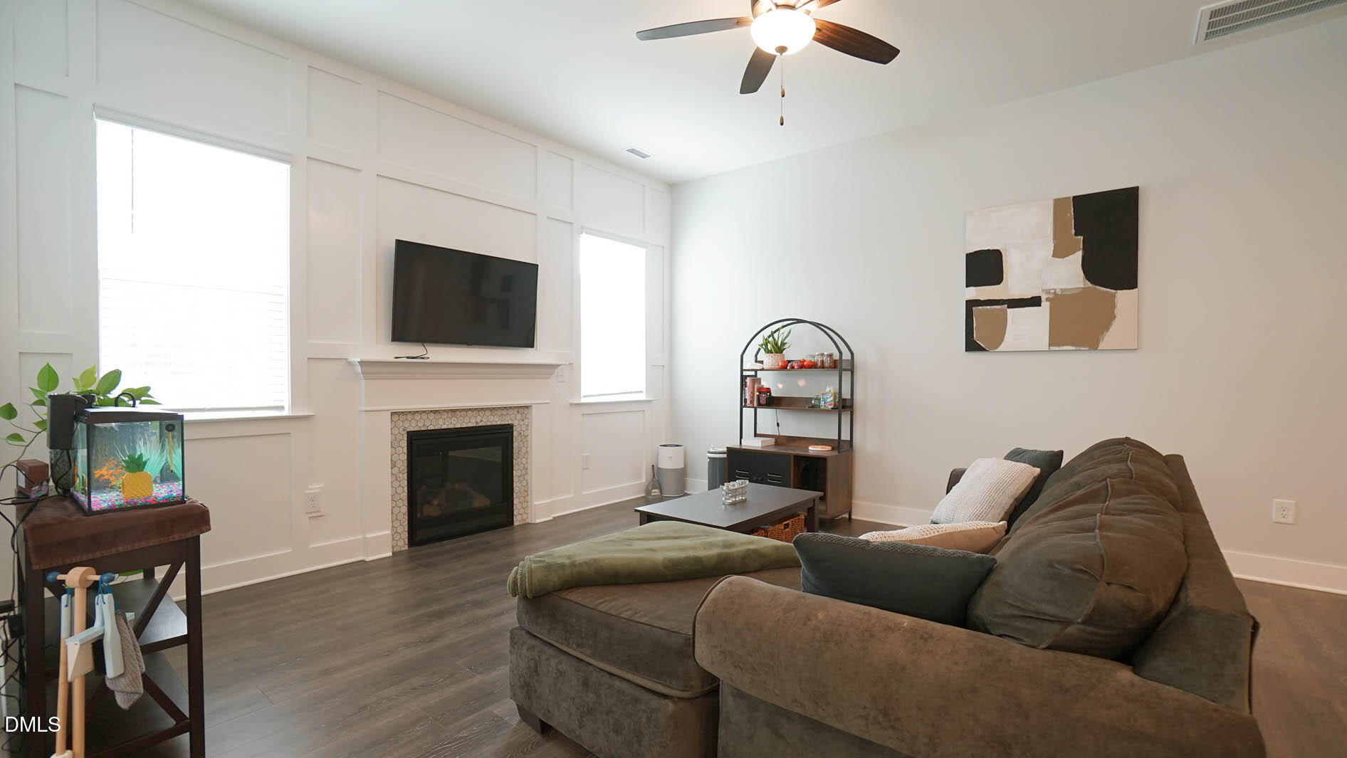693 South Wilma Street Angier, NC 27501 - Photo 17 of 51 a living room with furniture a fireplace and a flat screen tv