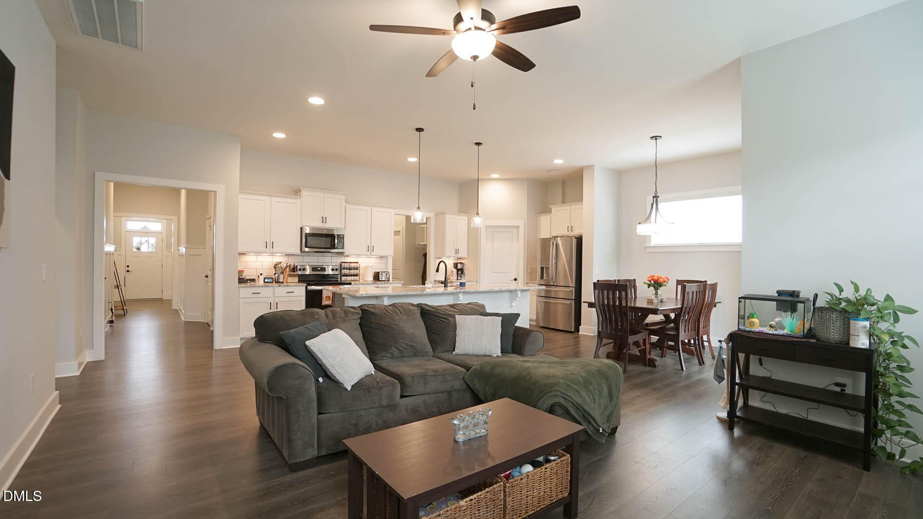 693 South Wilma Street Angier, NC 27501 - Photo 18 of 51 a living room with furniture kitchen view and a chandelier