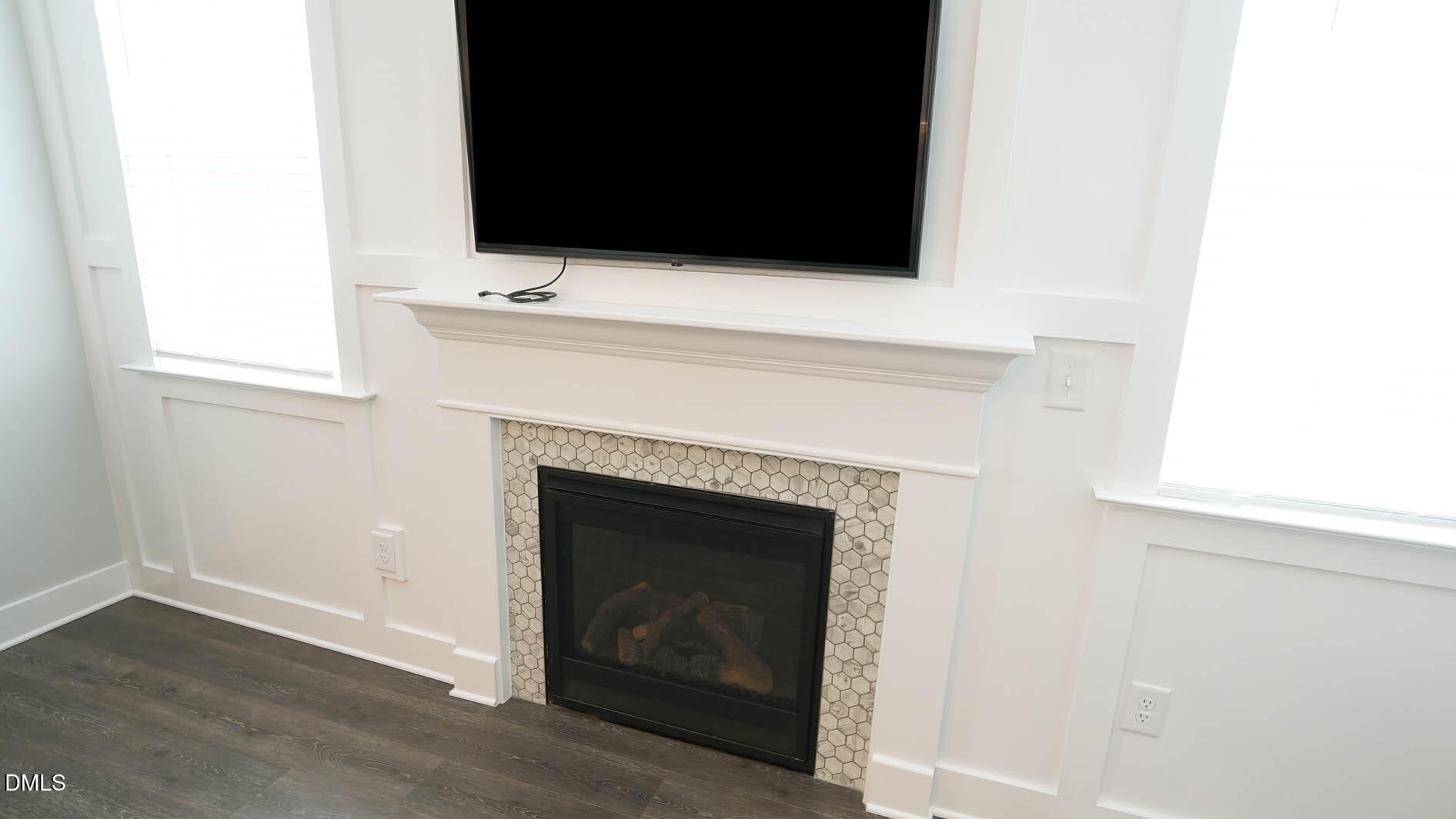 693 South Wilma Street Angier, NC 27501 - Photo 19 of 51 a living room with a fireplace and a flat screen tv