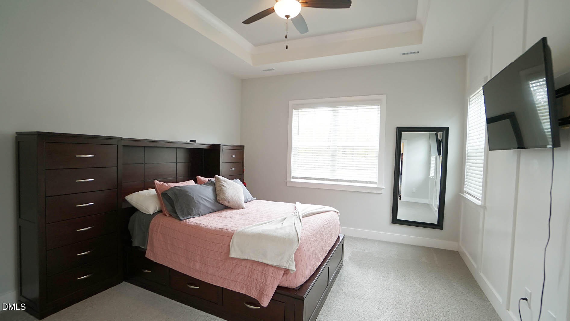 693 South Wilma Street Angier, NC 27501 - Photo 20 of 51 a bedroom with a bed and a flat tv screen on wall