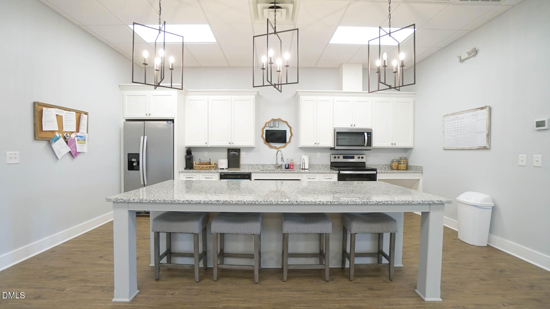 693 South Wilma Street Angier, NC 27501 - Photo 46 of 51 a kitchen with stainless steel appliances granite countertop a sink dishwasher a dining table and chairs with wooden floor