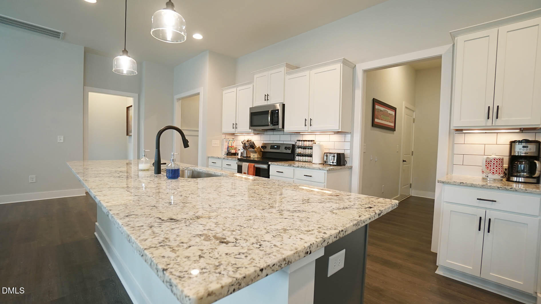 693 South Wilma Street Angier, NC 27501 - Photo 6 of 51 a kitchen with granite countertop a stove a sink a refrigerator and cabinets