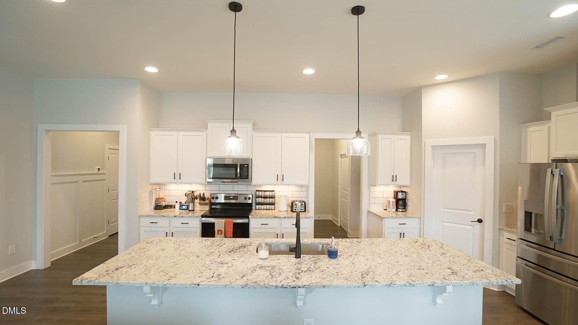 693 South Wilma Street Angier, NC 27501 - Photo 8 of 51 a kitchen with stainless steel appliances kitchen island granite countertop a refrigerator a stove a oven a sink with island and chairs
