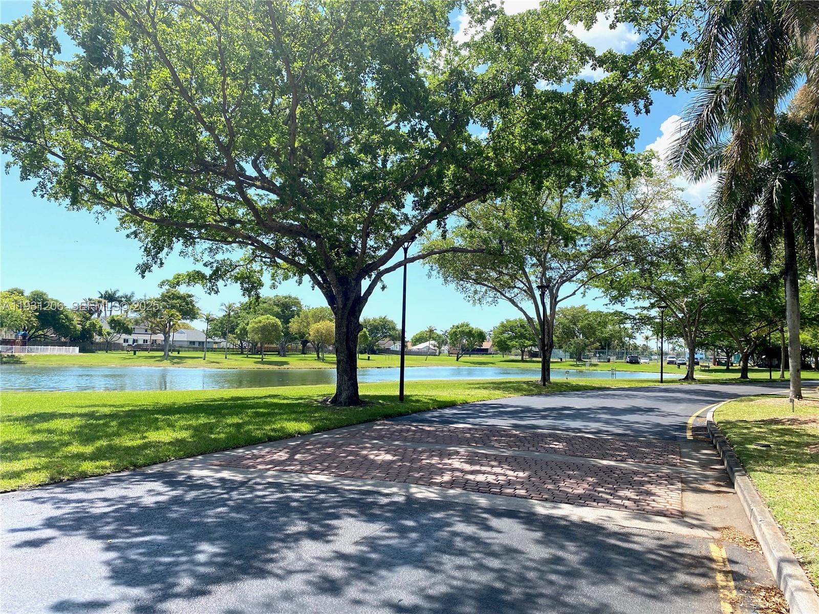 10059 Southwest 218th Street, Unit 10059 Cutler Bay, FL 33190 - Photo 15 of 15 a view of a park with large trees
